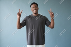 Man wearing dark grey t shirt showing peace sign image Product Image 1