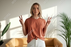 Woman peace gesture terracotta shirt white pants image Product Image 1