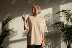 Woman wearing beige t shirt peace sign image Product Image 1