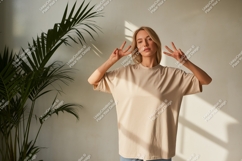 Woman wearing beige t-shirt peace sign image Product Image 1