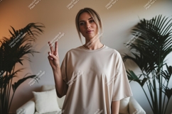 Woman wearing beige t shirt showing peace sign image Product Image 1