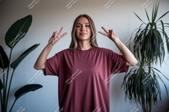 Woman wearing maroon t shirt making rock and peace signs Product Image 1