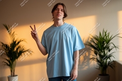 Young man wearing light blue t-shirt peace gesture Product Image 1