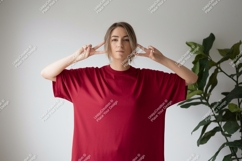 Woman wearing red t shirt making peace sign t-shirt Product Image 1