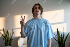 Young man peace gesture light blue shirt image Product Image 1