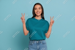 Young Woman Teal T Shirt Blue Jeans Peace Sign t-shirt Product Image 1