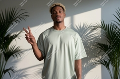 Man wearing light green t-shirt making peace Product Image 1