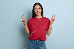 Woman red shirt blue jeans peace sign image Product Image 1