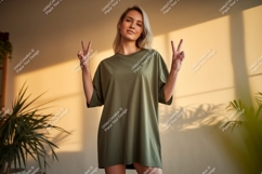 Woman wearing olive green t shirt making peace sign Product Image 1