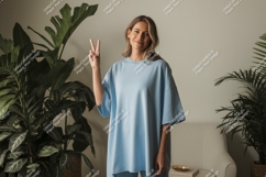 Young woman peace sign blue shirt image Product Image 1