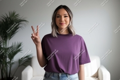 Woman wearing purple t-shirt making peace sign image Product Image 1