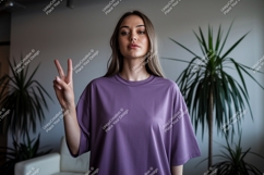 Woman wearing purple t-shirt making peace sign image Product Image 1
