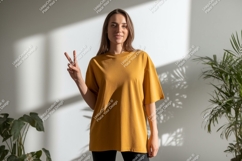 Woman wearing mustard t shirt peace sign image Product Image 1
