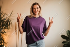 Woman wearing purple t shirt peace gesture image Product Image 1