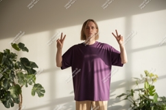 Young man purple t shirt peace sign image Product Image 1