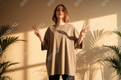 Woman wearing taupe oversized t shirt peace sign image Product Image 1