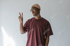 Man wearing maroon t shirt and tan beanie image Product Image 1