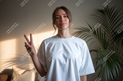 Woman wearing white t shirt showing peace sign image Product Image 1