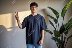 Man wearing dark blue t shirt and blue jeans image Product Image 1