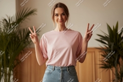 Woman wearing pink t shirt and jeans image Product Image 1