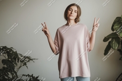 Woman wearing pink t shirt and blue jeans image Product Image 1