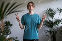 Man teal t shirt peace sign indoor image Product Image 1