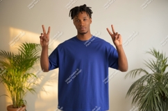 Young man peace sign blue shirt plants image Product Image 1