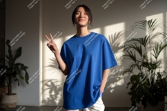 Young woman blue shirt peace sign image Product Image 1