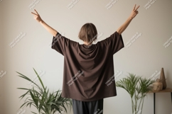 Person wearing brown t shirt arms raised image Product Image 1