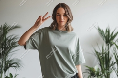 Woman wearing green t-shirt showing peace sign image Product Image 1