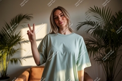 Woman wearing light green t shirt making peace sign Product Image 1