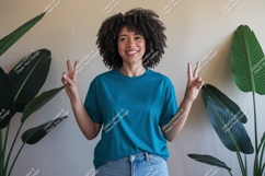 Woman wearing teal t shirt and jeans image Product Image 1