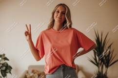 Woman wearing coral t shirt and denim jeans image Product Image 1