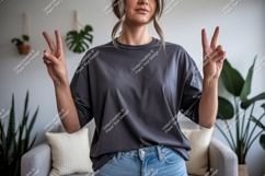 Woman wearing dark grey t shirt and jeans image Product Image 1