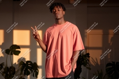 Young man peace sign coral shirt image Product Image 1