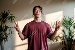 Young man peace sign indoors asian Product Image 1