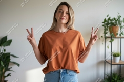 Woman wearing orange t shirt and jeans image Product Image 1