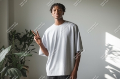 Young man grey t shirt peace sign indoors image Product Image 1