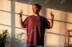 Woman wearing maroon t-shirt making peace sign image Product Image 1