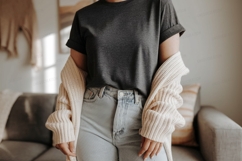 Woman wearing dark grey t shirt and light blue jeans Product Image 1