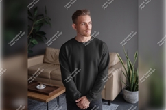 Man Wearing Dark Tshirt Mockup In Living Room Product Image 1