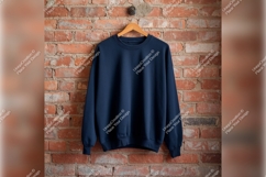 Blue Sweatshirt On Hanger Against Brick Wall Product Image 1