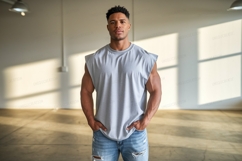Muscular man in grey tank top and ripped jeans image Product Image 1