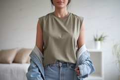 Woman wearing olive green sleeveless top and denim jacket Product Image 1