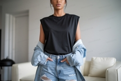 Woman wearing black sleeveless shirt and denim jacket Product Image 1