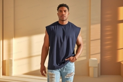 Muscular man wearing dark blue sleeveless shirt ripped denim Product Image 1
