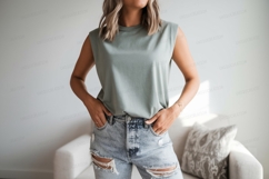 Woman wearing sleeveless top and ripped jeans image Product Image 1