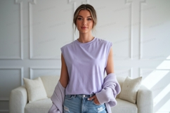 Woman wearing lavender top and denim jeans image Product Image 1
