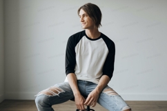 Young man wearing baseball shirt and ripped jeans image Product Image 1