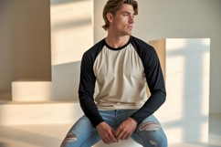 Man wearing baseball shirt and ripped jeans image Product Image 1